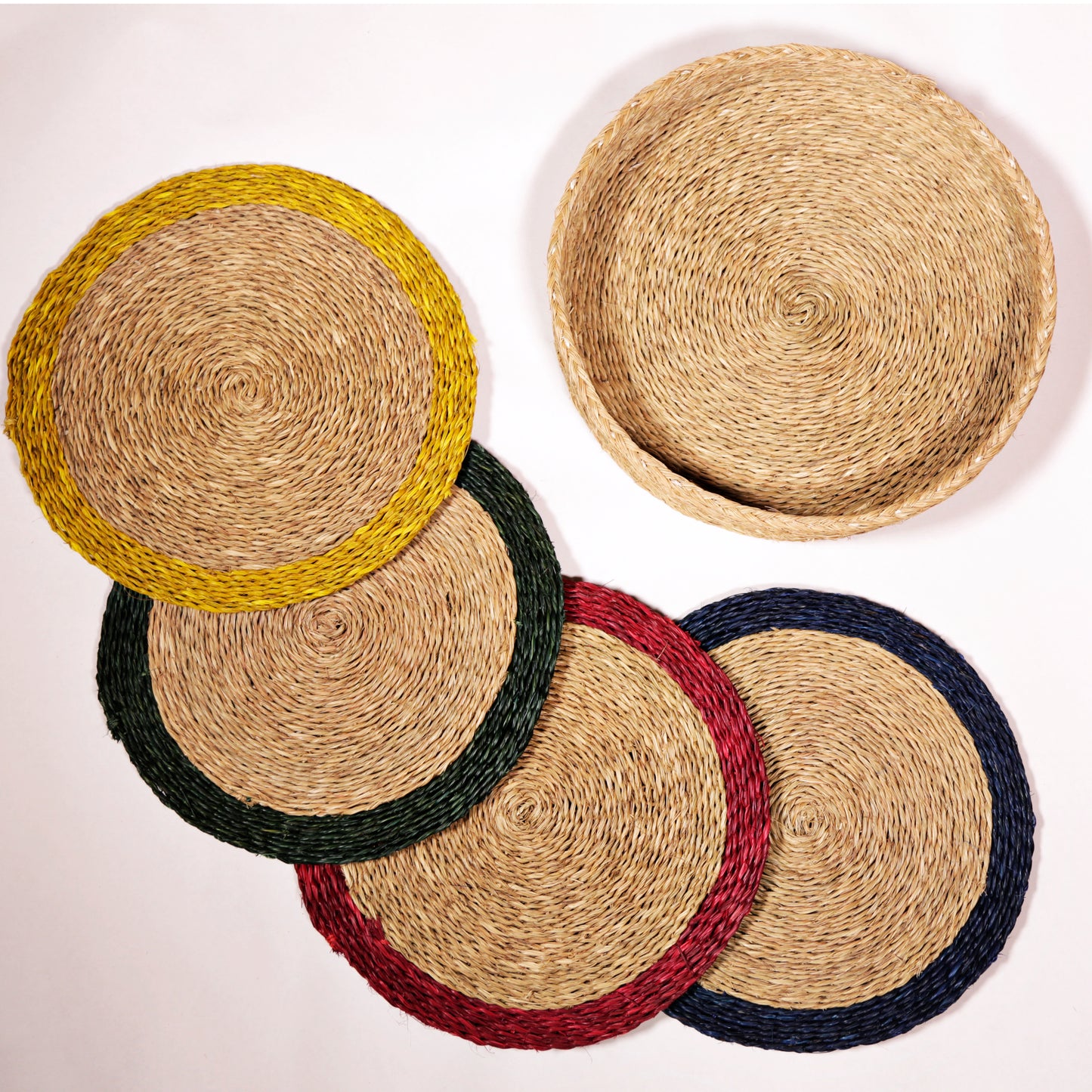 Set of four round mini grasswoven placemats with a pop of colour trim